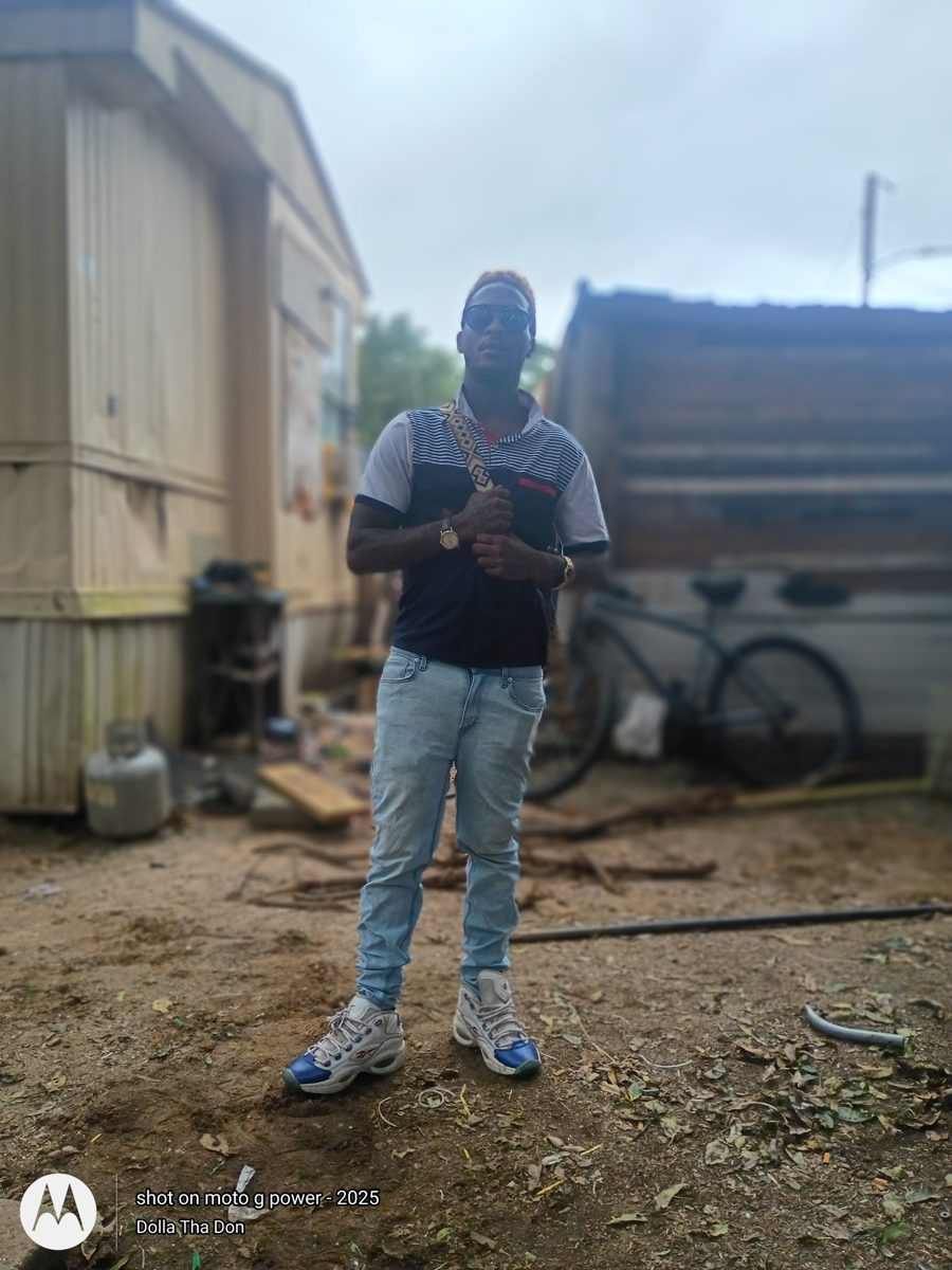Dolla Tha God standing outdoors in Hartwell